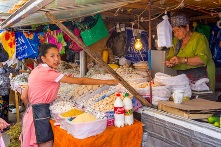 SHYMKENT, KAZAKHSTAN - JULY 19: Woman selling typical central asian dry cheese balls called kurut at Shymkent bazaar. July 2016のeditorial素材