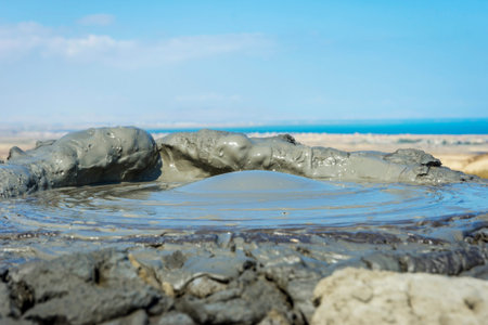 Mud volcano erupting mud bubble, Gobustan, Azerbaijan