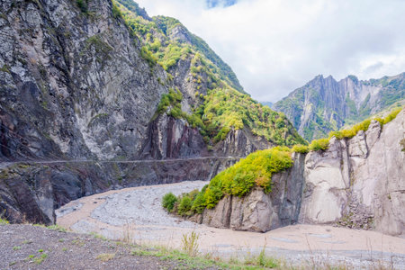 View over Lahich river bed torrent and vertical rocks in summer, Azerbaijanの写真素材