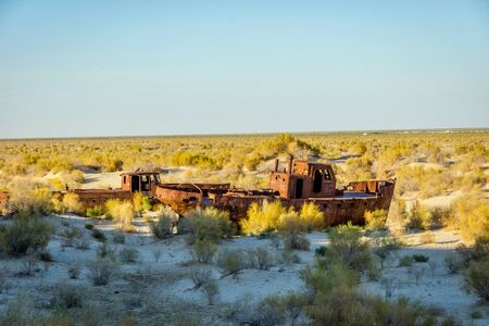 Old ships in the desert "ship cemetery" the consequence of Aral sea disaster, Muynak, Uzbekistanの写真素材