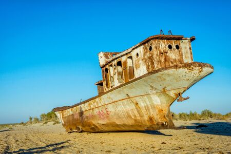 Old ships in the desert "ship cemetery" the consequence of Aral sea disaster, Muynak, Uzbekistanの写真素材