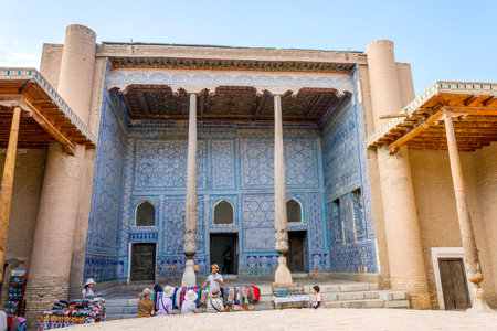 KHIVA, UZBEKISTAN - SEPTEMBER 7: Tourist guide explaining about old madrassa to visitors in Khiva old town. September 2016のeditorial素材