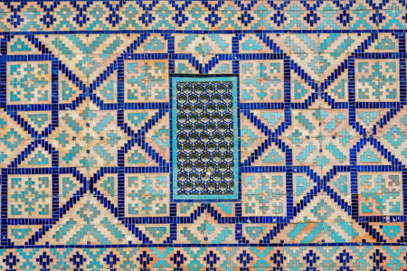 Window on a wall of blue tiles and mosaic of Registan mausoleum, Samarkand, Uzbekistanの写真素材