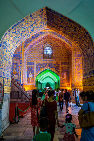 SAMARKAND, UZBEKISTAN - AUGUST 28: Visitors at colorful ornamental interior full of tiles and mosaics of Tilya Kori Madrasah in Registan, Samarkand, Uzbekistan. August 2016のeditorial素材