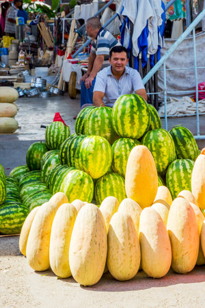 SAMARKAND, UZBEKISTAN - AUGUST 28: Man selling best uzbek watermelons and honey melons at Siab bazaar local market in Samarkand. August 2016のeditorial素材
