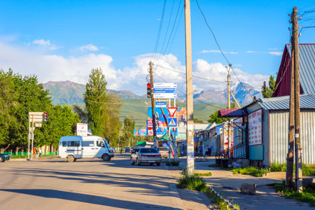 KARAKOL, KYRGYZSTAN - AUGUST 2: View over the street with cars and shops in Karakol city. August, 2016 のeditorial素材