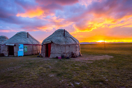 Yurts and mountains around Song Kul lake in a sunset light, Kyrgyzstan