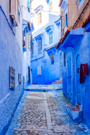 Narrow street painted blue in Chefchaouen city, Moroccoの写真素材