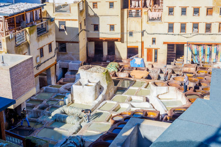 FEZ, MOROCCO - DECEMBER 10: Man working at the pools at on of the tanneries in Fez old town. December 2016のeditorial素材