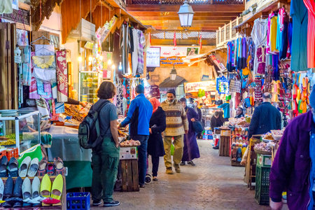 FEZ, MOROCCO - DECEMBER 10: Bazaar with clothes and food for sale in Fez medina aka. old town....