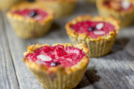 Raspberry muffins on an old wooden tableの写真素材
