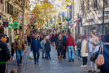 GIBRALTAR - NOVEMBER 19: People walking on the street in Gibraltar downtown on a sunny day. November 2016のeditorial素材