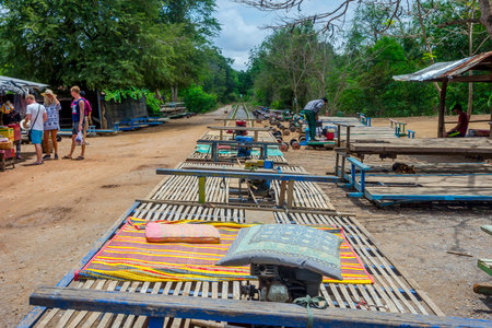 BATTAMBANG, CAMBODIA - APRIL 1: Preparing carriages for a ride with bamboo railway. April 2017のeditorial素材