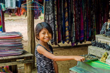 BATTAMBANG, CAMBODIA - APRIL 1: Young local girl posing at souvenir shop at bamboo railway station. April 2017のeditorial素材