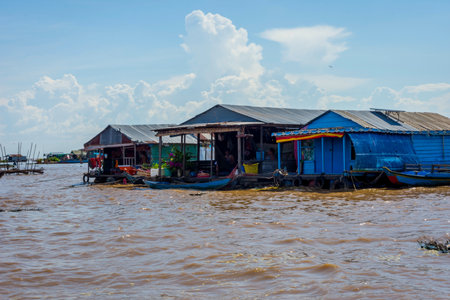 TONLE SAP, CAMBODIA - APRIL 8: People sitting in front of the boat house in Tonle Sap floating village. April 2017のeditorial素材