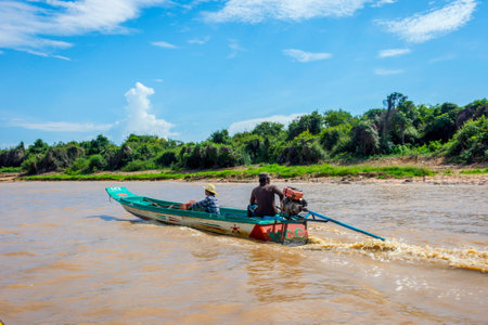 TONLE SAP, CAMBODIA - APRIL 8: Two man in a boat in water canal going towards Tonle Sap floating village. April 2017のeditorial素材