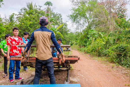BATTAMBANG, CAMBODIA - APRIL 1: Guys moving the carriage at bamboo railway. April 2017のeditorial素材