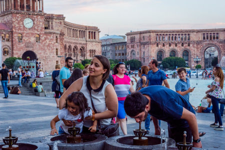 YEREVAN, ARMENIA - AUGUST 2: People drinking water from the fountain at the Republic square on hot summer day. August 2017のeditorial素材