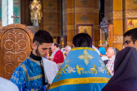 Batumi, Georgia - August 27, 2017: Priest reading a holy book in religious ceremony in Holy Mother Virgin Nativity Cathedral in Batumiのeditorial素材