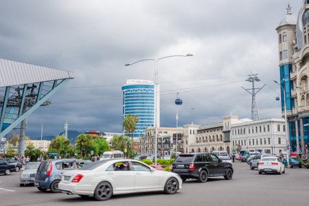 Batumi, Georgia - August 27, 2017: Traffic in the downtown of Batumi and cable car in the sky.のeditorial素材