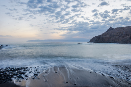 Beach Playa de Caleta in twilight with the view to Teide and Tenerife, La Gomera, Canary islandsの写真素材