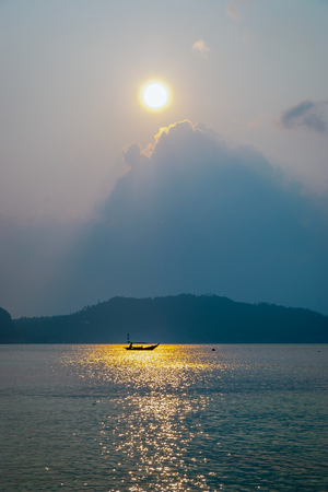 Silhouette of a fishing boat in a sunset, Koh Pha Ngan island, Thailandの写真素材