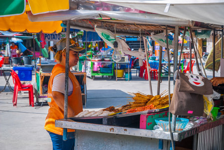 Koh Phangan, Thailand - Sep 2015: Women selling food at street food stall in Koh Phangan centerのeditorial素材