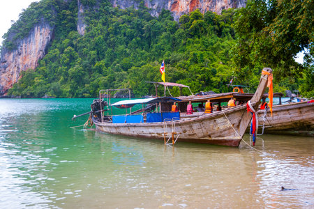 Typical thai boats over the sandy beach on Krabi islands, Thailandのeditorial素材