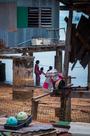 Koh Lanta, Thailand - Oct 4, 2015: kids playing by the water under the house on pillars in Koh Lanta islandのeditorial素材