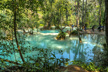 Luang Prabang, Laos - Feb 2016: People visiting Kuang Si waterfalls and taking photos, one of the biggest attractions in the areaの写真素材