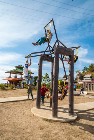 Pai, Thailand - Jan 2016: Group of young travellers playing on giant swing wheel near Pai, Thailandのeditorial素材