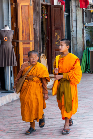Luang Prabang, Laos - Feb 2016: Two buddhist monks walking on the street in downtown of Luang Prabangのeditorial素材