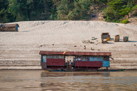 Mekong river, Laos - Feb 2016: Laotian family living in a floating house on Mekong riverのeditorial素材