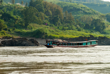 Long boat going down the Mekong river, Laosのeditorial素材