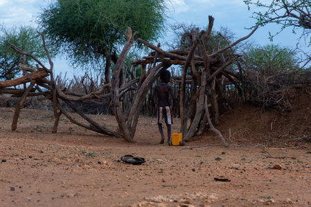 Turmi, Ethiopia - Nov 2018: Hamer tribe kids playing with self made truck from a water canister. Omo Valleyのeditorial素材