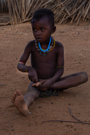 Turmi, Ethiopia - Nov 2018: Young Hamer tribe kid playing next to the house, Omo valleyのeditorial素材
