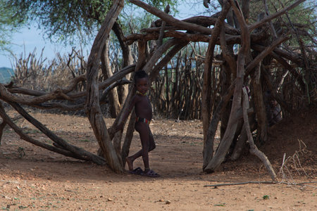 Turmi, Ethiopia - Nov 2018: Group of hamer tribe kids at the entrance to the yard. Omo valleyのeditorial素材
