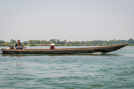 Nakasong, Laos - Mar 2016: Driving a boat on Mekong riverのeditorial素材