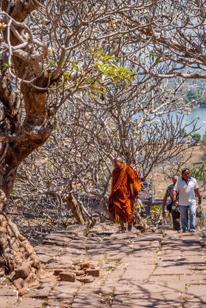 Muang Champassak, Laos - Feb 2016: Buddhist monk walking up the stairs at Wat Phou temple, Laosのeditorial素材