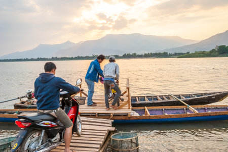 Muang Champassak, Laos - Feb 2016: Transporting motorbikes over Mekong river in Laosのeditorial素材