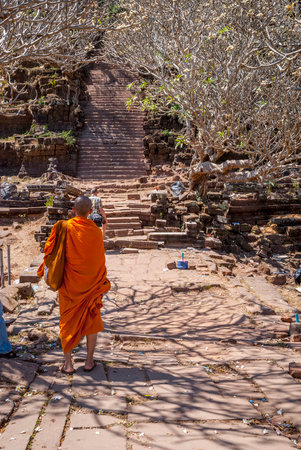 Muang Champassak, Laos - Feb 2016: Buddhist monk walking up the stairs at Wat Phou temple, Laosのeditorial素材