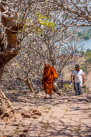 Muang Champassak, Laos - Feb 2016: Buddhist monk walking up the stairs at Wat Phou temple, Laosのeditorial素材