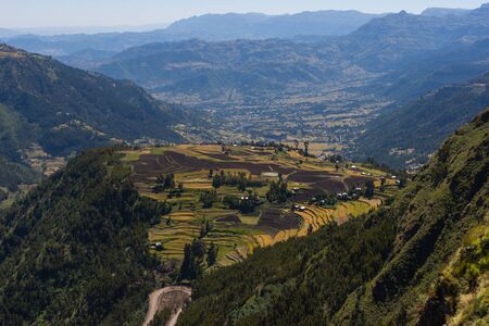 View to Ethiopian countryside - fields and houses, over the hillsの写真素材