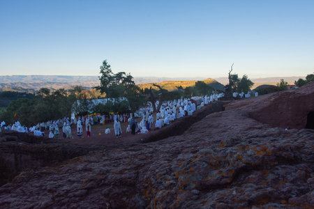 Lalibela, Ethiopia - Nov 2018: Pilgrims dressed in traditional ethiopian white colors gathering outside the Lalibela underground churches.のeditorial素材