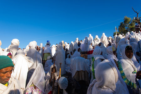 Lalibela, Ethiopia - Nov 2018: Pilgrims dressed in traditional ethiopian white colors gathering outside the Lalibela underground churches.のeditorial素材