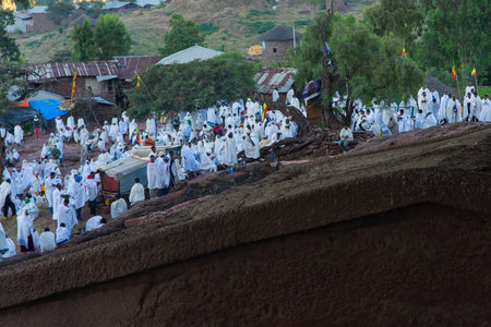 Lalibela, Ethiopia - Nov 2018: Pilgrims dressed in traditional ethiopian white colors gathering outside the Lalibela underground churches.のeditorial素材