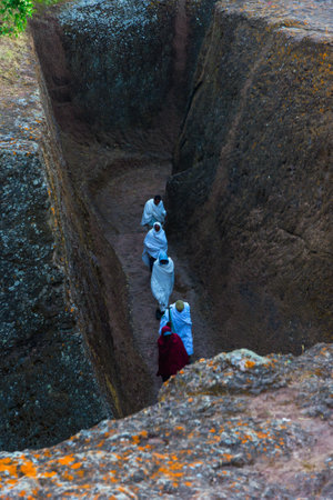 Lalibela, Ethiopia - Nov 2018: People walking in the tunnels at churches of Lalibela, which are excavated into rockのeditorial素材