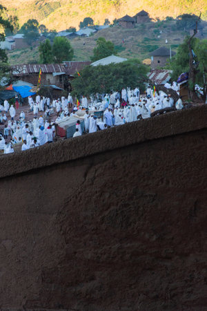 Lalibela, Ethiopia - Nov 2018: Pilgrims dressed in traditional ethiopian white colors gathering outside the Lalibela underground churches.のeditorial素材