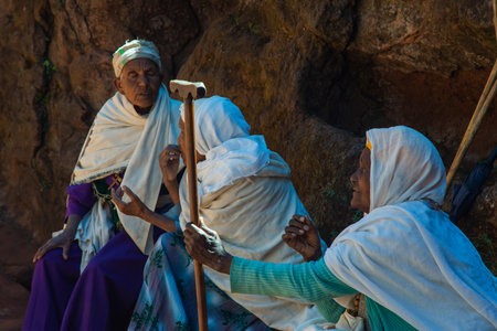 Lalibela, Ethiopia - Nov 2018: Group of elderly people sitting and talking next to the underground church in Lalibelaのeditorial素材