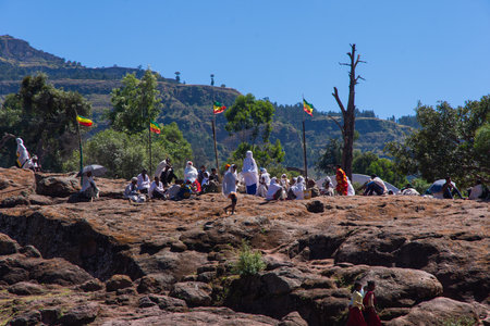 Lalibela, Ethiopia - Nov 2018: Pilgrims dressed in traditional ethiopian white colors gathering outside the Lalibela underground churches.のeditorial素材